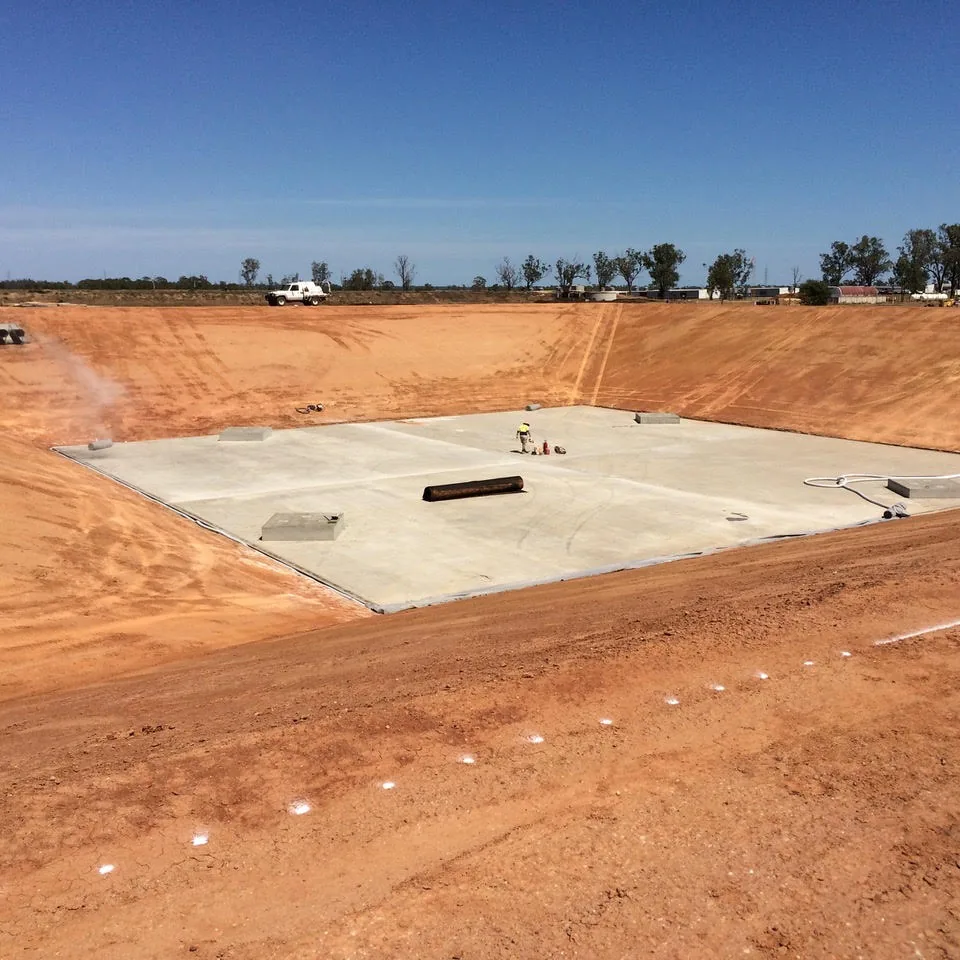 Concrete area within an excavated earth cut.