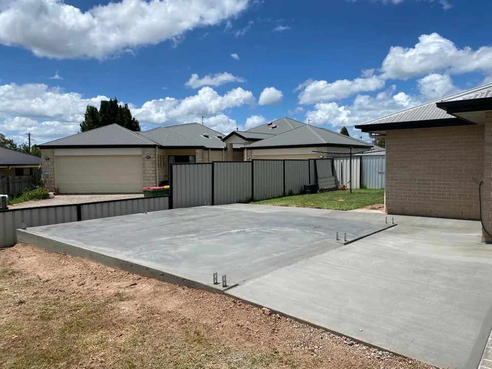 Concrete slab beside residential buildings.