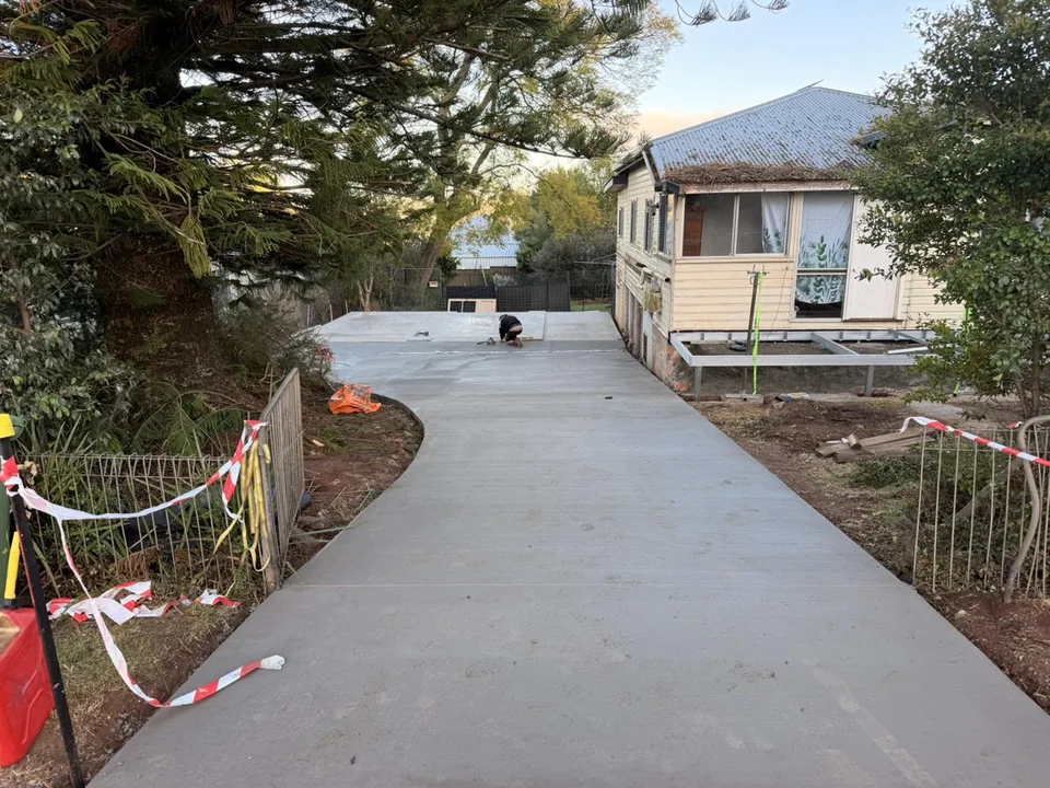 Concrete access area alongside a residential building.