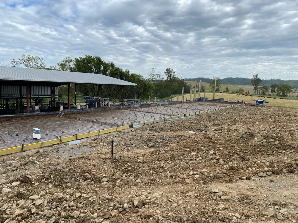 Reinforcement and formwork beside an open-sided structure.