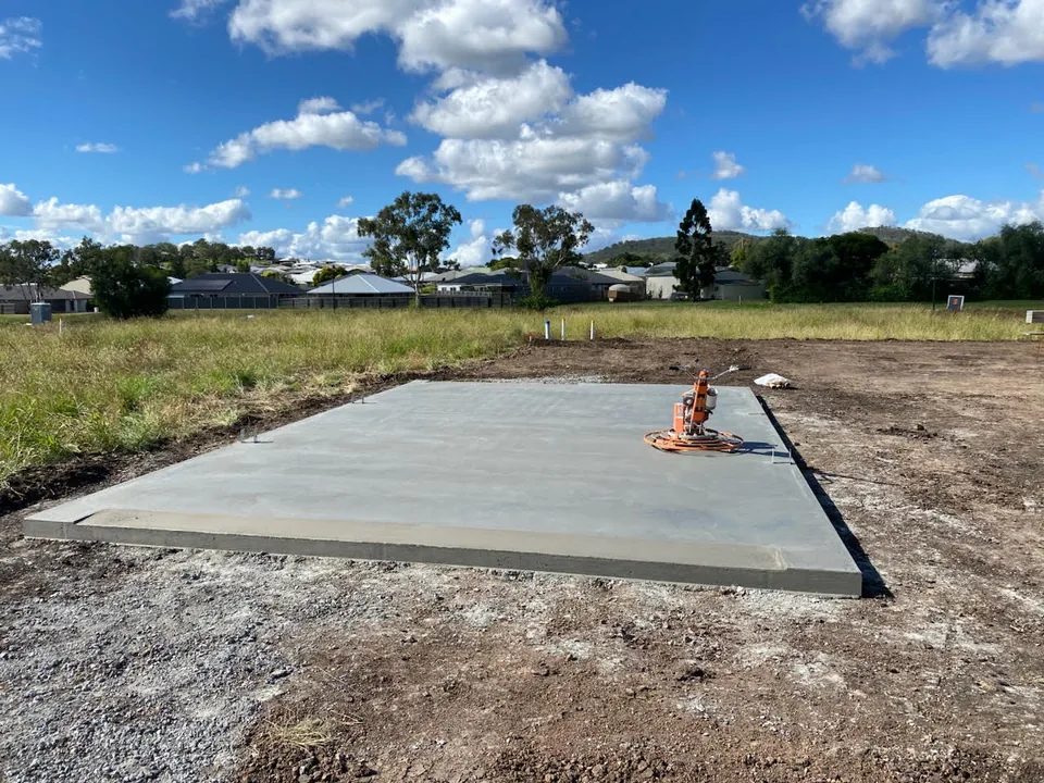Concrete slab with a power trowel on its surface.